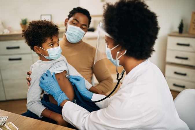 Doctor listening to child's lungs