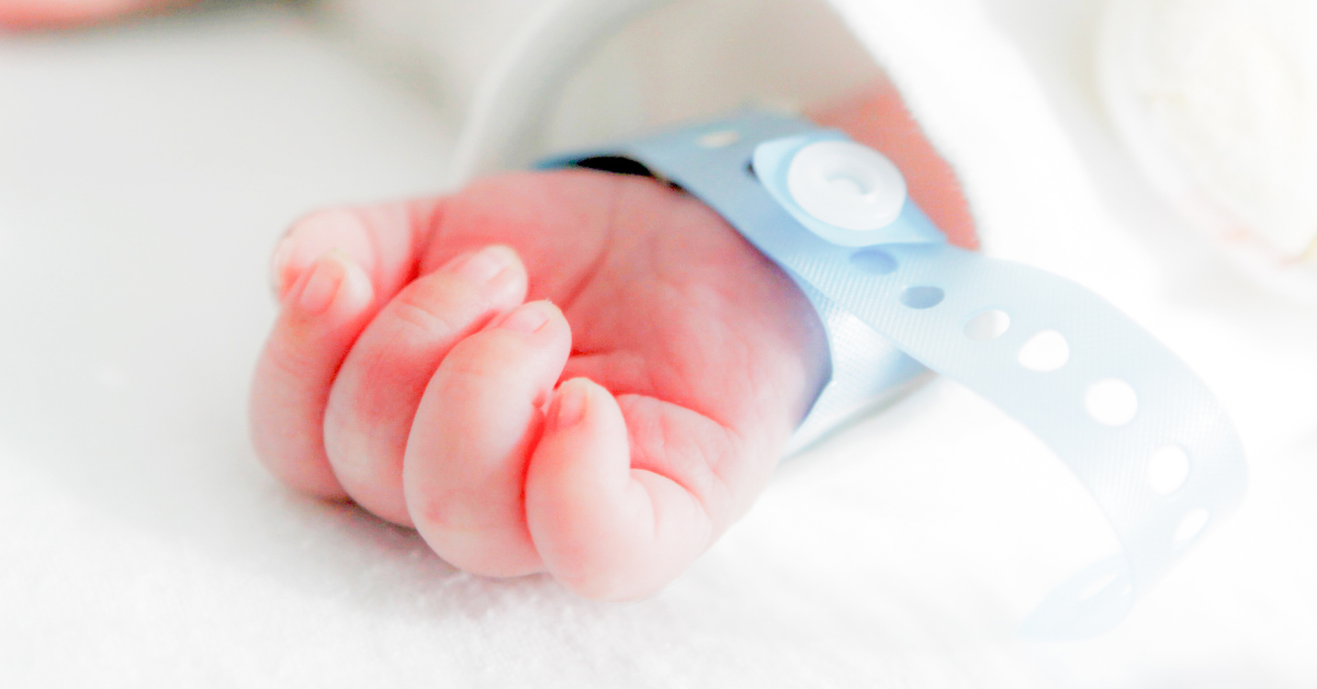 newborn hand with hospital wristband